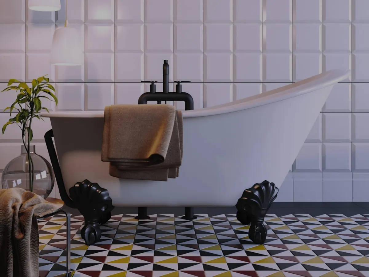 Bagno con vasca freestanding e pavimento in ceramica a triangoli geometrici colorati